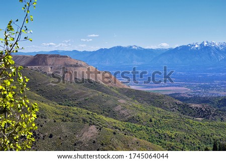 Rocky Mountain Wasatch Front peaks, panorama landscape view from Butterfield Canyon Oquirrh range by Rio Tinto Bingham Copper Mine, Great Salt Lake Valley in fall. Utah, United States.