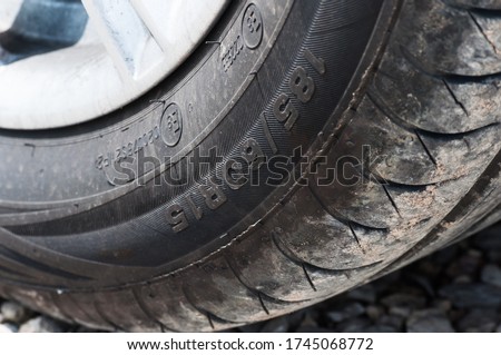 185/60 R15 photo of a car tire tread with traces of sand and road dust and dirt. car travel. road adventures, car themes. background for a screen saver or desktop for a car enthusiast