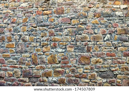 Gray stones of medieval wall in historical center of Huy, Belgium