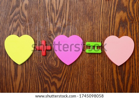 Three blank heart shaped stickers. Mathematical signs plus and equal. Love concept. Background