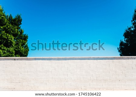 White wall in an isolated city with nobody with blue sky background.