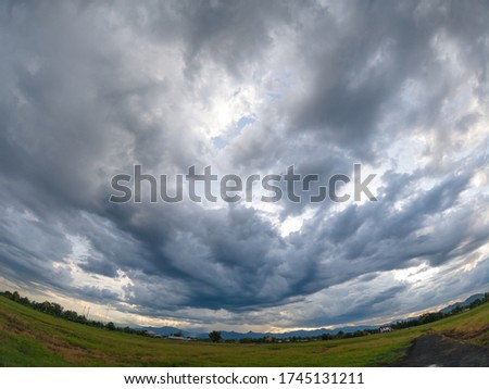 Landscape of rural field scene with dramatic huge cloud in the sky befor storming