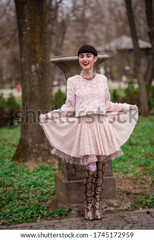 Smiling Fashion Model Standing At Park