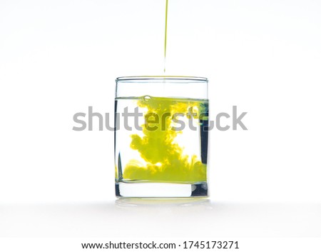 Yellow ink in water, color abstraction, color explosion in a glass.