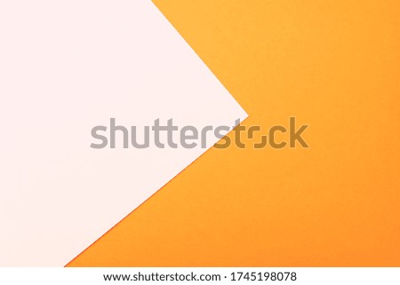 Two colored bright paper texture orange and white as background, top view with place for text
