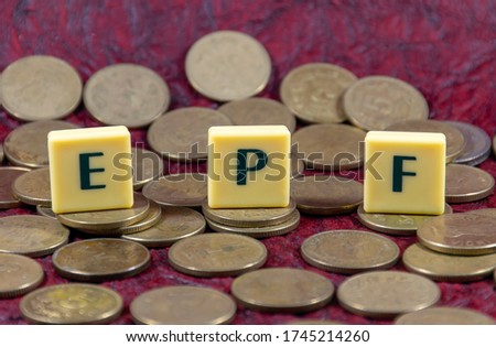 Concept Employee provident fund or PPF word design with Indian five rupee coin for various type of financial transaction or stock market option 