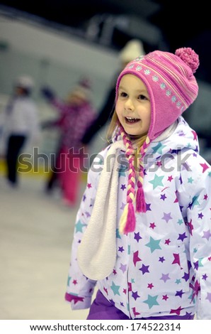 little girl learning ice skating