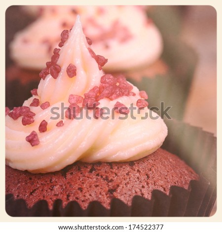 Red velvet cupcake closeup. Filtered to look like an aged instant photo.