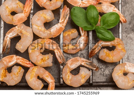 Tiger shrimps on metal grill. Grilled seafood. Flat lay. Healthy nutrition
