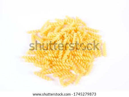Raw fusilli pasta on a white background