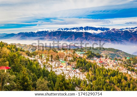 View of beautiful homes in town and snow covered Pir Panjal range (Inner Himalayan region) at Dalhousie, Himachal Pradesh, India. Royalty-Free Stock Photo #1745290754