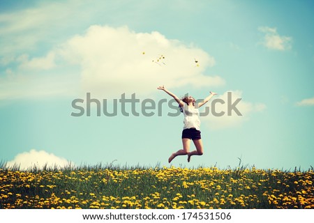 Happy woman jumping on blossom meadow. Beautiful day on field. Royalty-Free Stock Photo #174531506