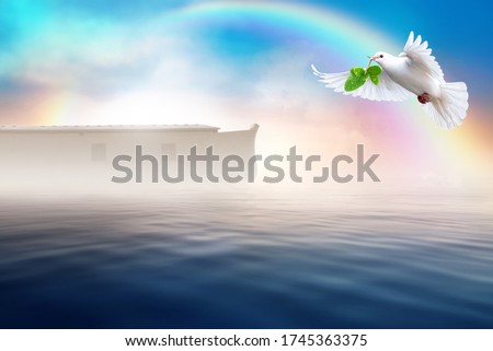 White dove flying with olive branch in its beak. Noah's ark bible story theme concept. Royalty-Free Stock Photo #1745363375