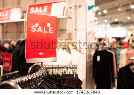 a sign with the inscription sale in a clothing store and a place for an inscription. Boutique billboard