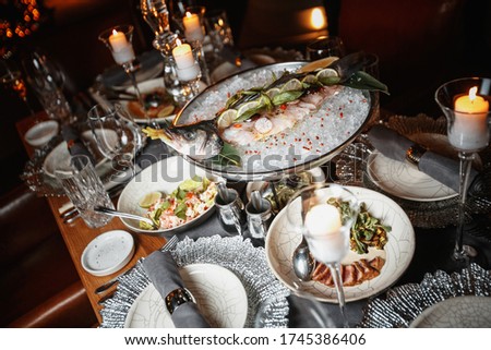 Serving a table with plates and canndles. Hight quality photo