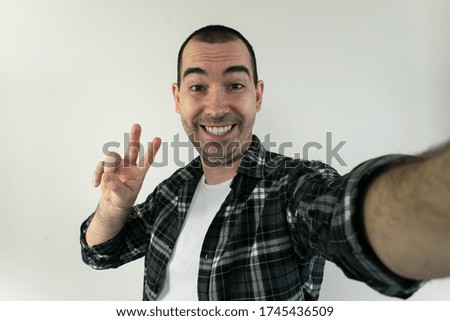 male stand white background take selfie blogger content creator smile happy influencer