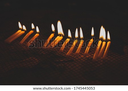 Candle lights in the darkness. Abstract candles background. Hope, fire.