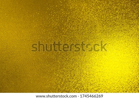 Closeup view of sparkling yellow glitter background. metallic shimmer texture of material, glimmering wall background