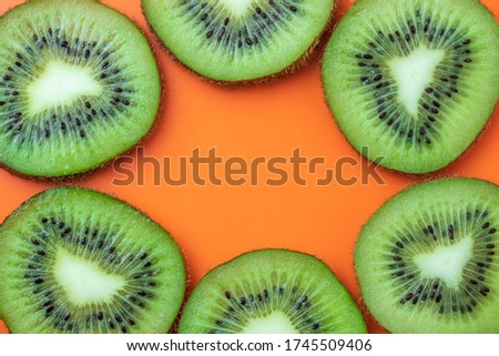 Kiwi fruit, tropical frame, food texture. Mockup with empty space, copy space for text. Summer background, orange pattern