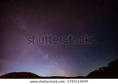 Spring Milky Way and satellites in the night sky.
