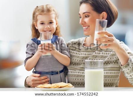 girl drinking milk at the kitchen Royalty-Free Stock Photo #174552242