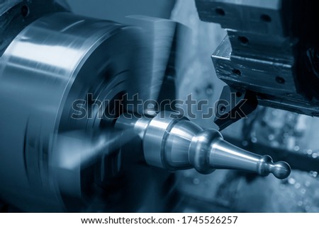 The  CNC lathe machine finish cutting the metal shaft parts. The hi-technology metal working processing by CNC turning machine .