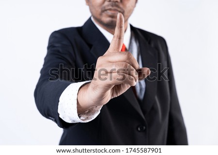 Closed up shot of a man in suit showing "NO" sign, seamless white background