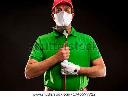 Close-up of a golf player with golf irons, gloves and coronavirus face mask, isolated on black background