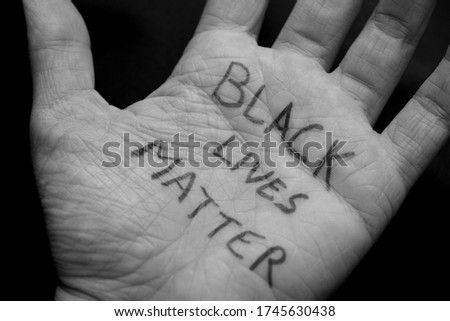 Black and white picture of a Caucasian girl showing support to the Black Lives Matter movement. 