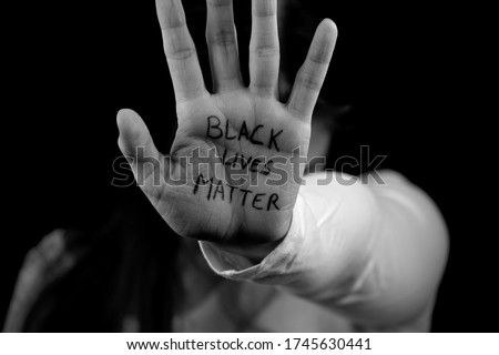 Black and white picture of a Caucasian girl showing support to the Black Lives Matter movement. 