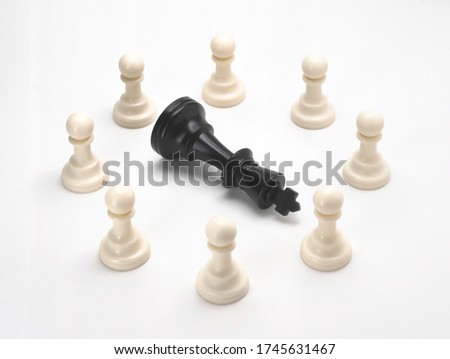 Black king chess dies in a group of pawn chess isolate on white background. black & white chess figures for business concept - Unity is strength, strategy, Leader, Power, Success, Competition
