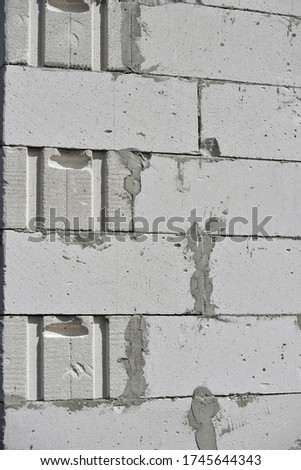 raw brickwall with visible concrete lines and some scratches on the grey surface of bricks. build concept.