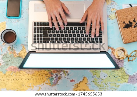 Top view female hands using laptop on world map booking next travel destinations - Young trip agent woman browsing online - Future traveling and technology concept  Royalty-Free Stock Photo #1745655653
