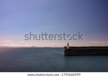Burntisland harbour light house with views across the forth river, Scotland.