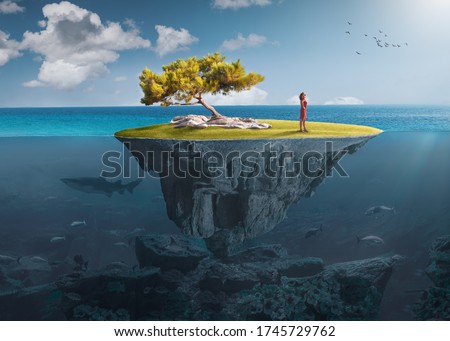 Beautiful underwater view of floating island above and below water surface in turquoise waters of tropical ocean with lone woman and marine life. Royalty-Free Stock Photo #1745729762
