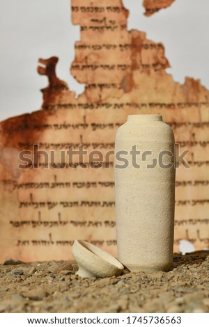 A model of a Jar used for the Dead Sea scrolls against a blurred background of the Isaiah scroll Royalty-Free Stock Photo #1745736563