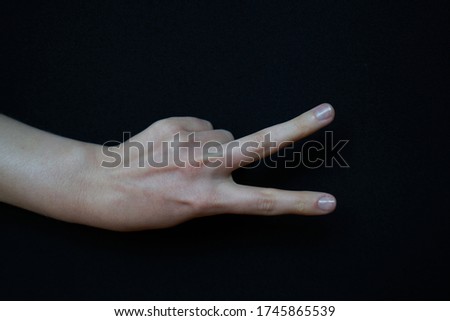 Isolated woman hand closeup making gestures on black background