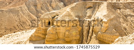 Caves of Qumran, manuscripts of the Dead Sea. Web banner in panoramic view. Royalty-Free Stock Photo #1745875529