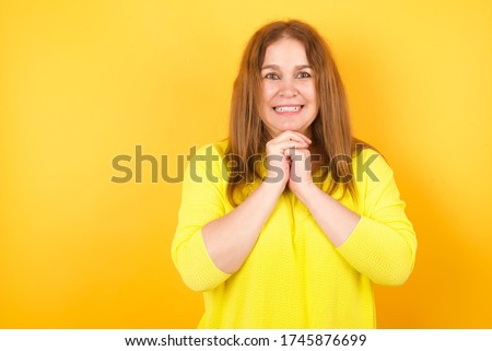 Positive adorablemiddle aged woman model smiles happily, glad to receive pleasant news