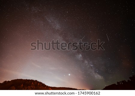 Spring Milky Way and satellites in the night sky.
