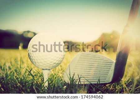 Playing golf, ball on tee and golf club about to shot. Vintage, retro style