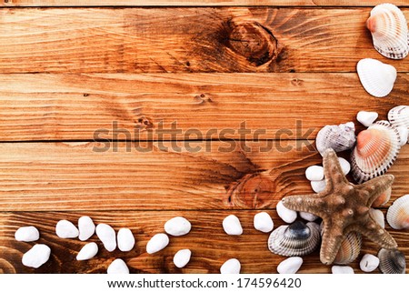 Seashell frame on wooden background 