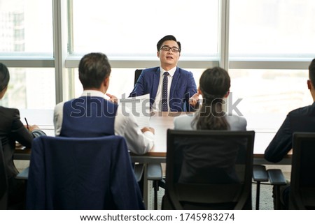 over confident young asian business person talking big in front of hr interviewers during job interview Royalty-Free Stock Photo #1745983274