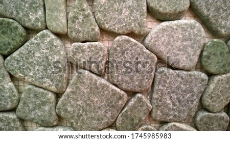 Stone wall background. Natural Stone for Landscaping. Suburban Real Estate. Material for construction. Building wall. Selective focus.
