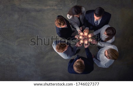 Teamwork and brainstorming concept with businessmen that share an idea with a lamp. Concept of startup Royalty-Free Stock Photo #1746027377