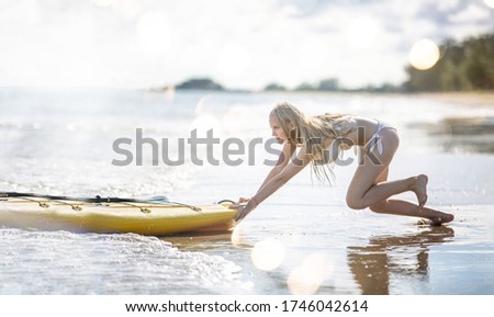 Woman with kayak by the tropical beach. Kayaking tour in Phuket, Thailand, woman relaxing in a kayak Summer seascape beach and blue sea water.
