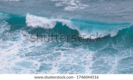 Breaking ocean wave background seen from above, in Bali Indonesia. Marine landscape scene in stormy weather, generating high waves and tides.
