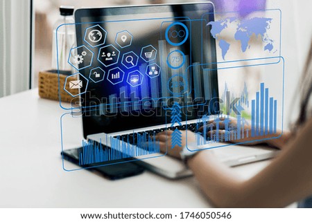 Hand of businesswoman using smart laptop computer, Digital marketing media and virtual globe shape diagram, Business Financial icons graphs, Work from home. Blurred image. Double exposure.