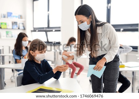 Teacher, children with face mask at school after covid-19 quarantine and lockdown. Royalty-Free Stock Photo #1746069476