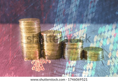 stacks of coins with business graph. The concept of economic crisis, falling incomes. Double exposure. Digital editing. Market analysis, economy or business development strategy.